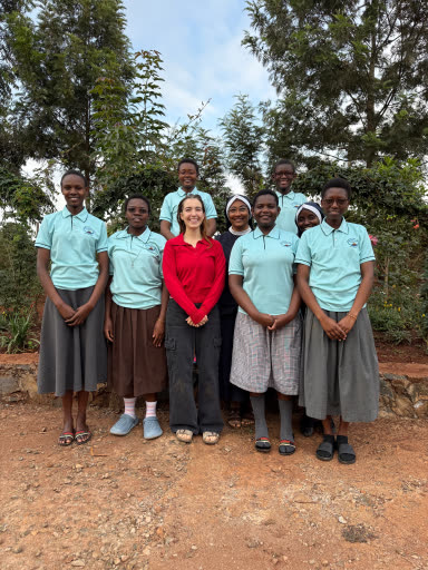 StudyTme standing with students and teachers in Kenya